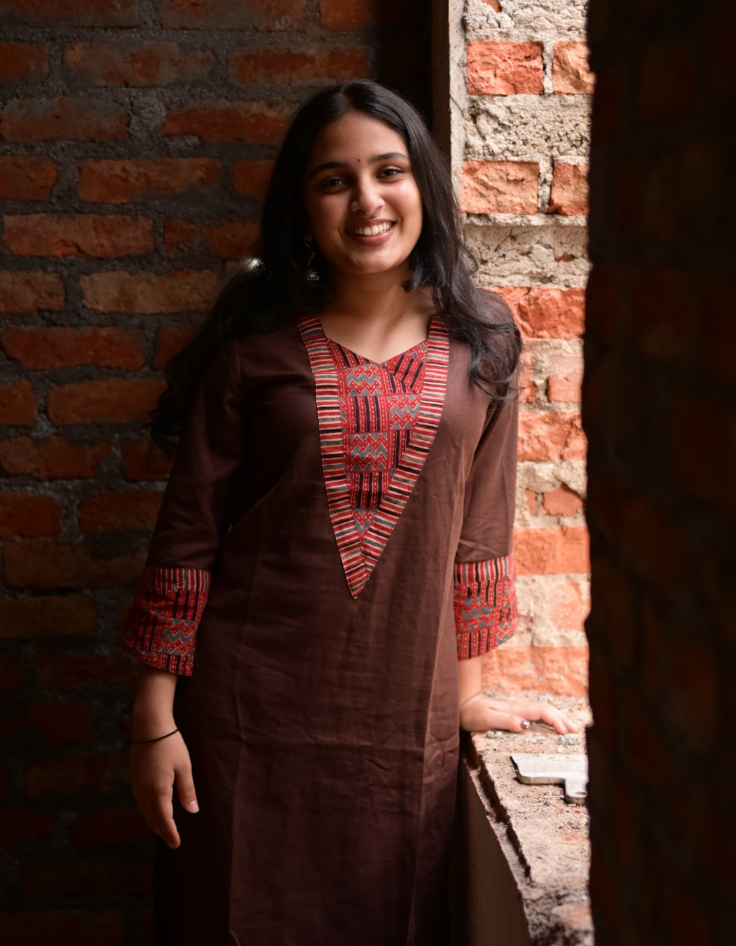 "TARA"BROWN BASE AND PINK AJRAKH PRINTED PATCH KURTI